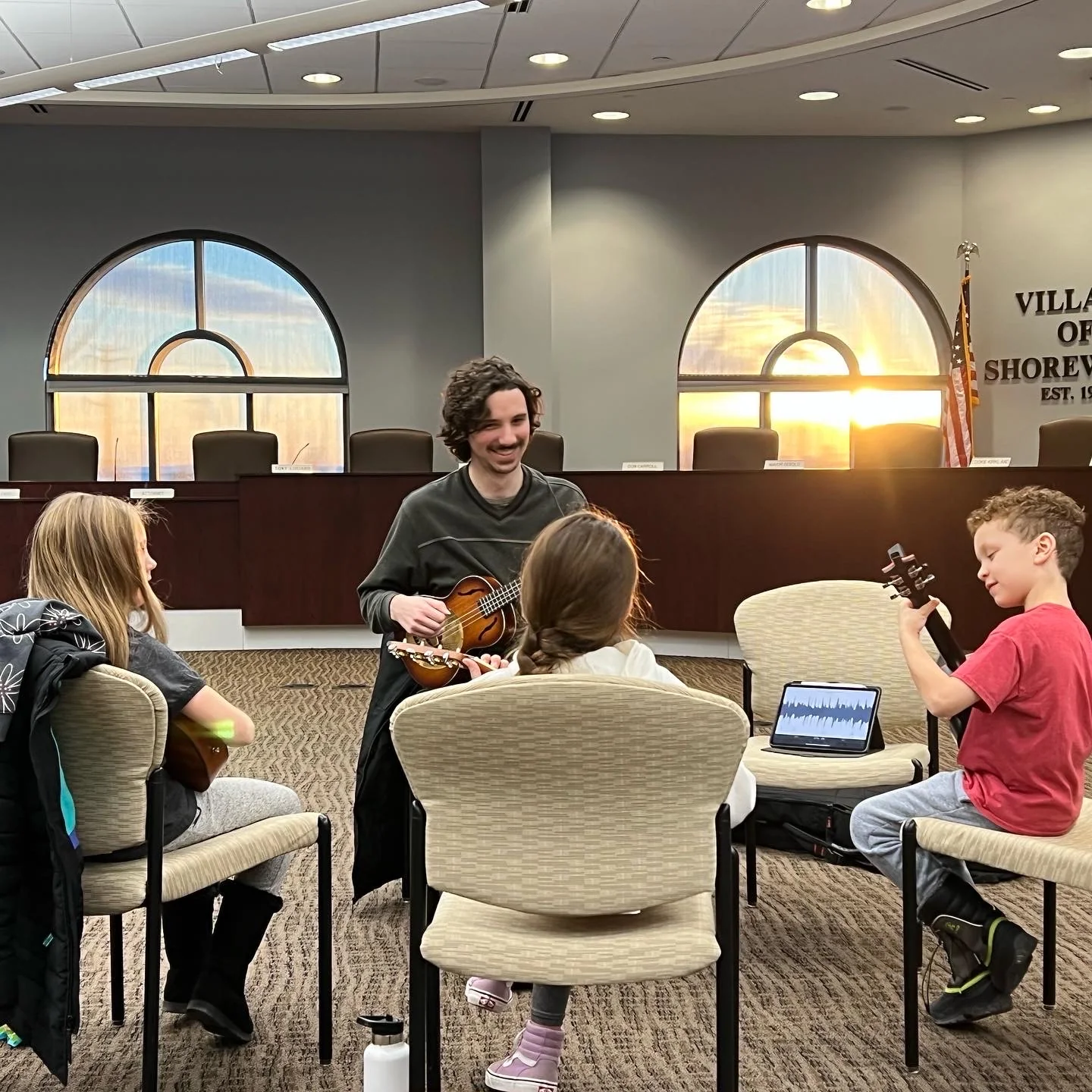 A small group learning ukulele together
