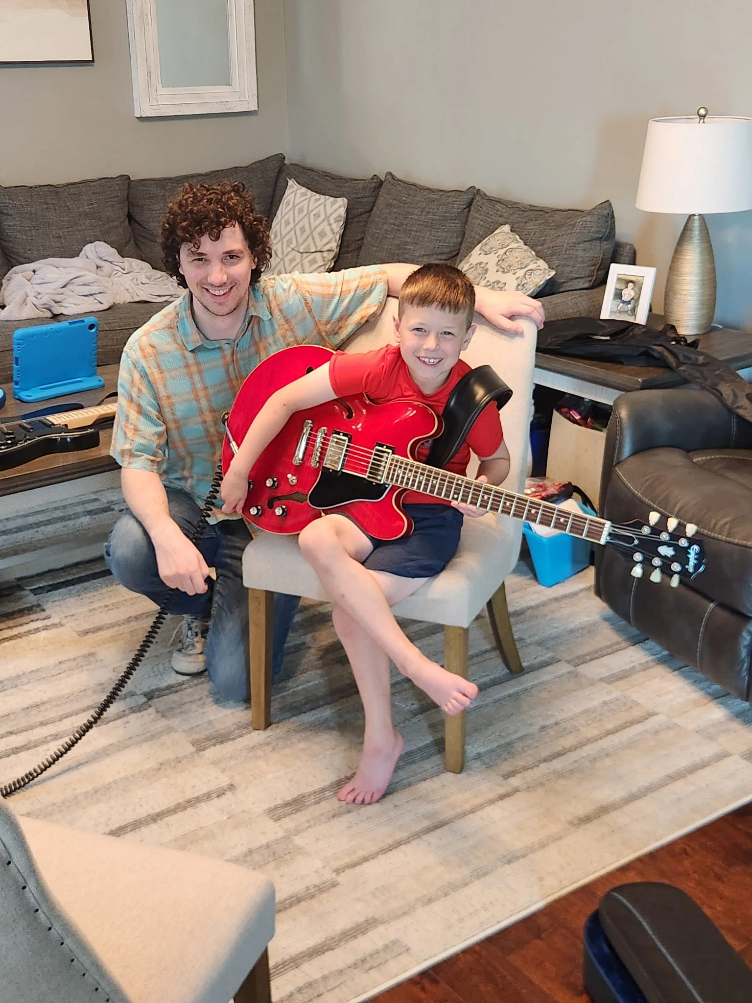 A teacher and young student during an in-home guitar lesson
